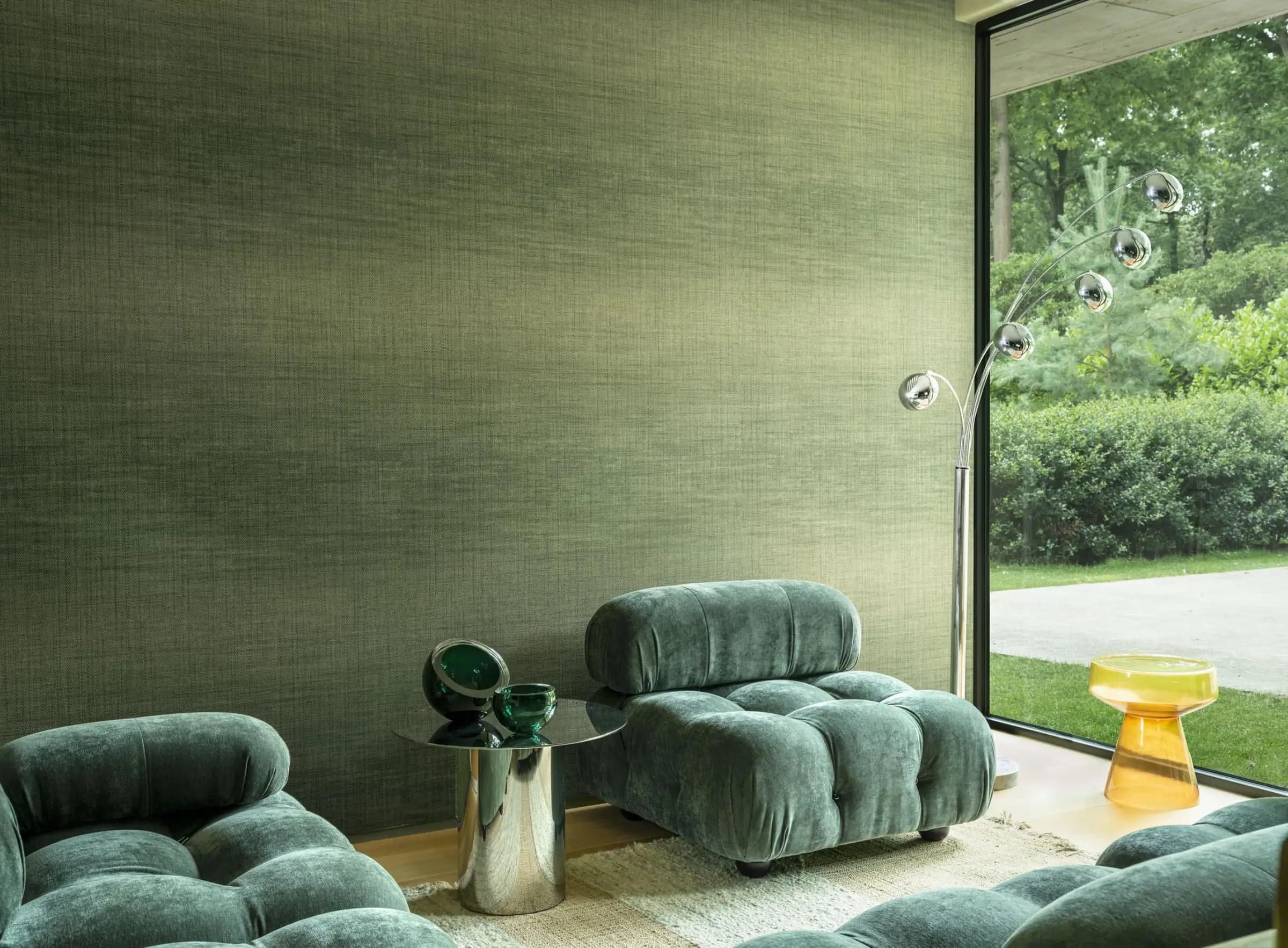 Calm blue interior with embossed wall, chair and garden
